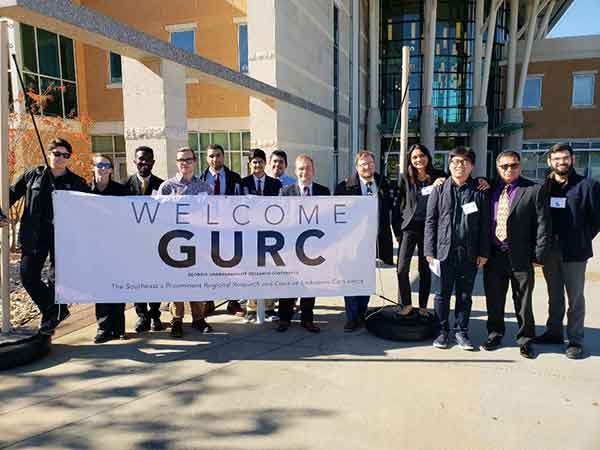 Undergraduate research partners Carnell Tate (third from left) and Alisa Machiwalla (fourth from right) attended the GURC conference with their peers and faculty mentors from the Southern Polytechnic College of Engineering and Engineering Technology in November 2018.  