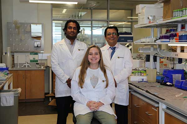 katie in lab with peers and professor