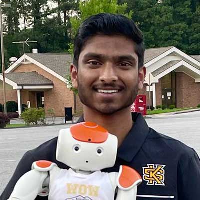 student scholar holding robot