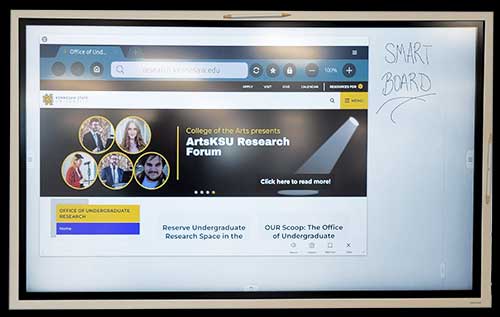 Photo of KSU SmartBoard in the office of research includes a touchscreen and two styluses