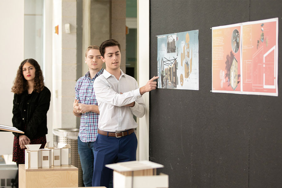 architecture students showing their work on the wall.