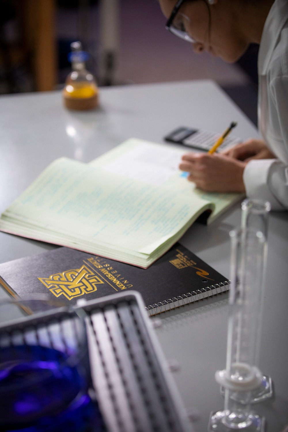 ksu student in lab using their notebook.