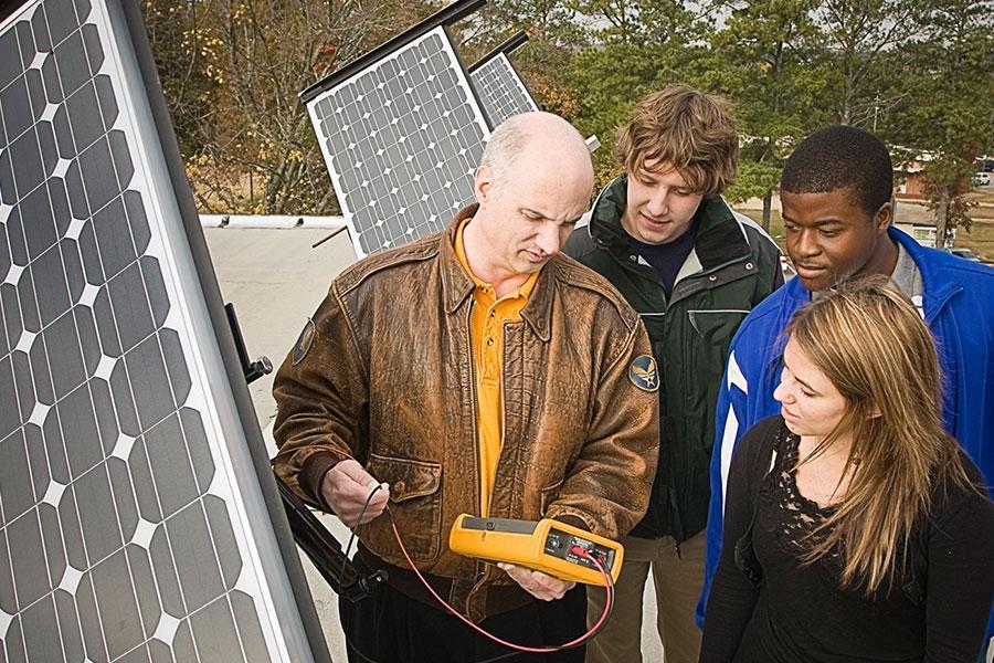  / Professor Tippens explains solar arrays to EET students