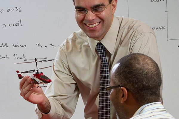 professor showing helicoptor design model to class