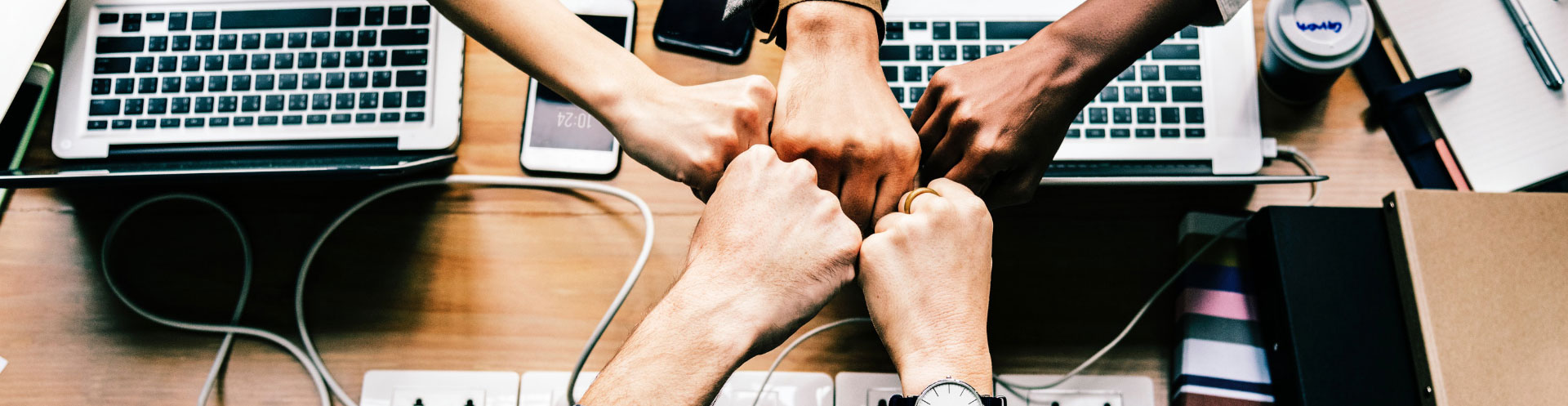 hands fist-bumping in a circle to show teamwork