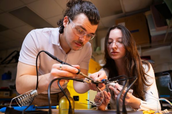 KSU SPCEET students soldering electronic components in a workshop