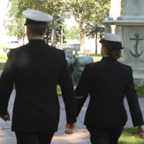 Two Kennesaw State ROTC cadets in uniform walking together along a scenic path, showcasing camaraderie and discipline.