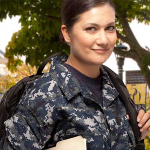 A woman in military uniform from Kennesaw State ROTC holds a book, symbolizing education and service in the armed forces.