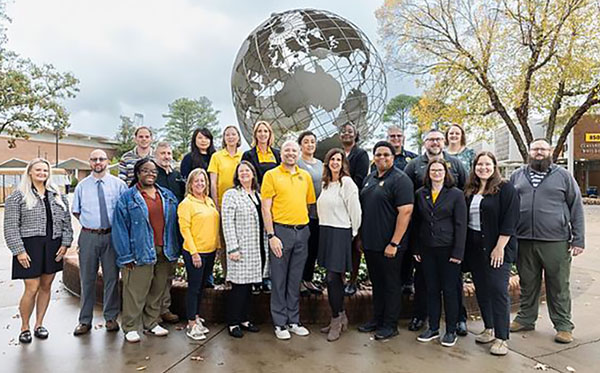 staff senate group shot in front of campus globe