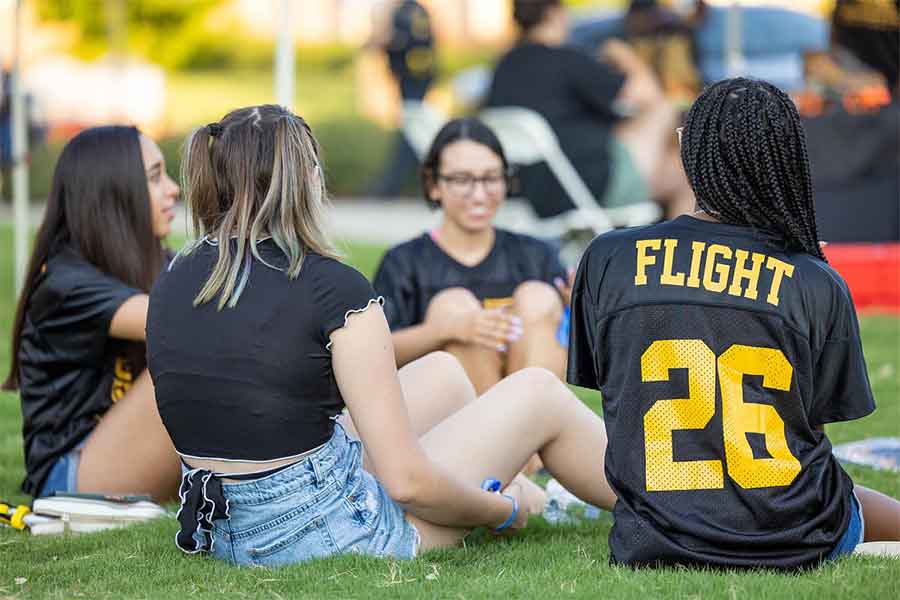 flight students sitting in the grass