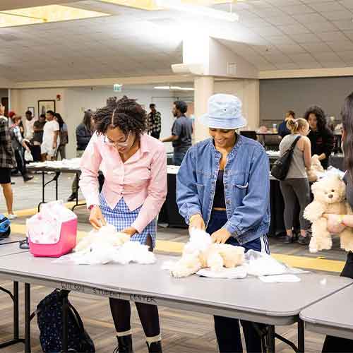 ksu students at the be true event stuffing teddy bears.