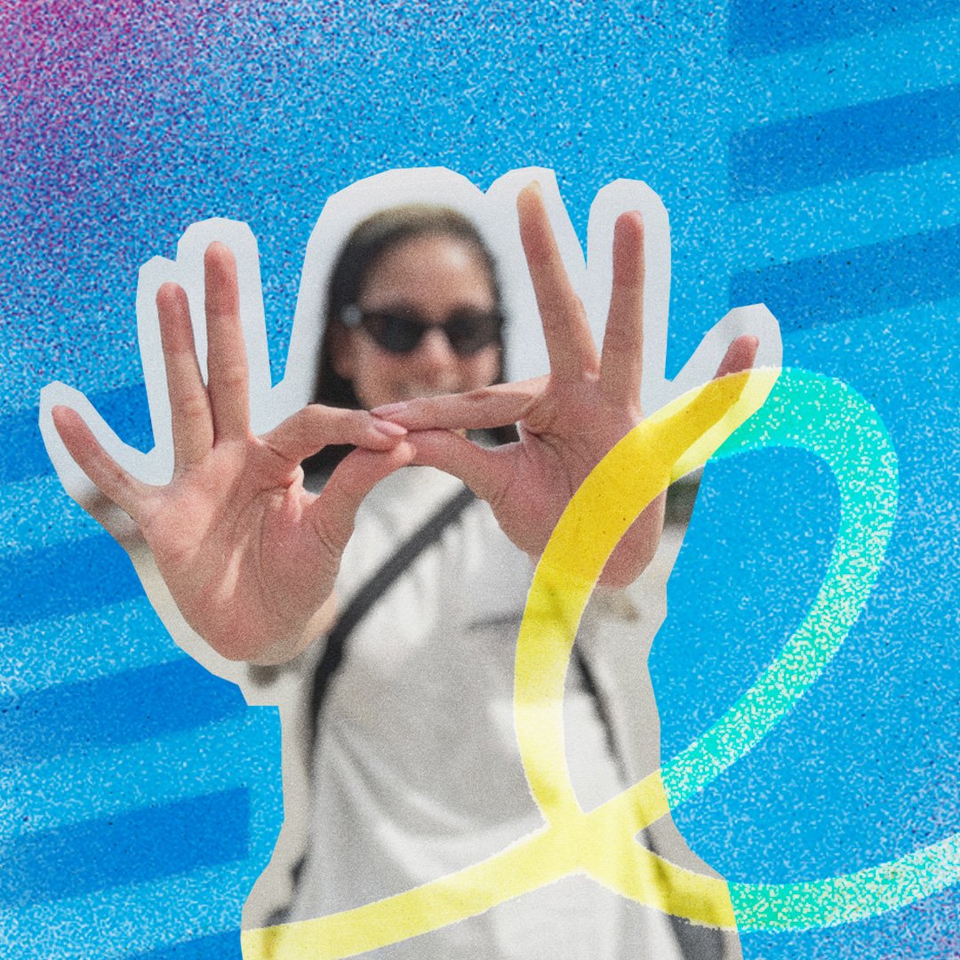 Summer @ KSU student holds hands up forming Owl Eyes