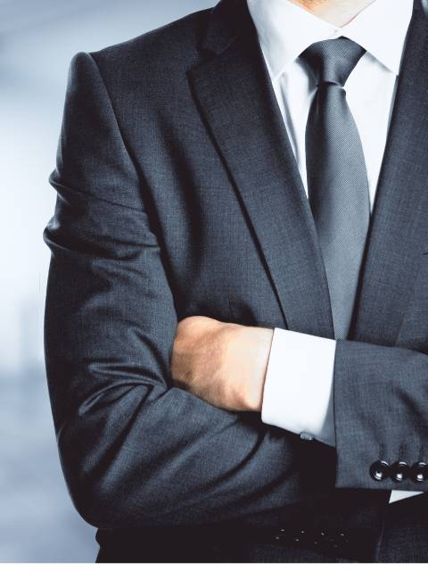 person in business suit with crossed arms