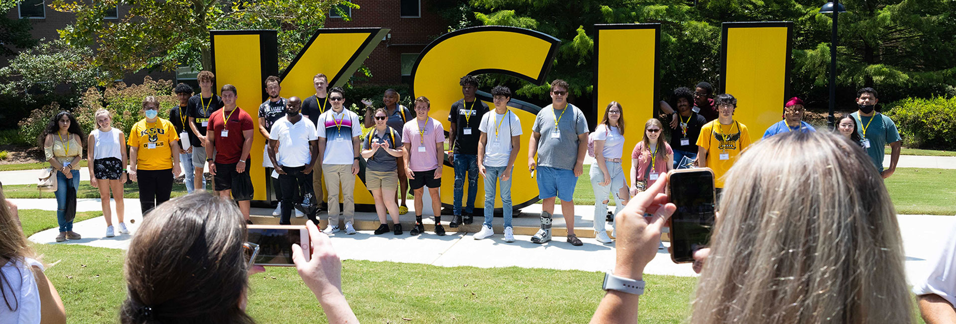 Student tour poses by KSU sign